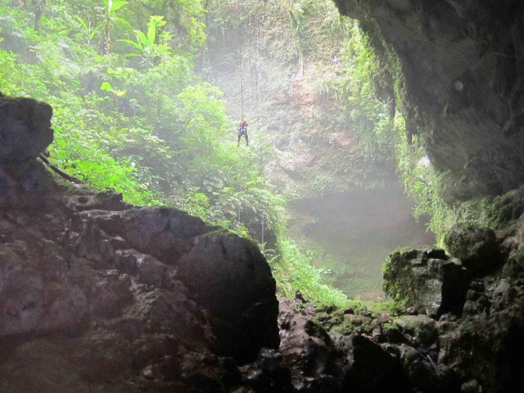 Rapelling down through a waterfall in the jungles of Puerto Rico.