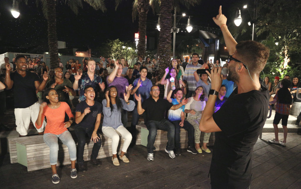 Free outdoor entertainment at Disney Springs attracts shoppers and families. Photo by Gregg Newton for WDW.