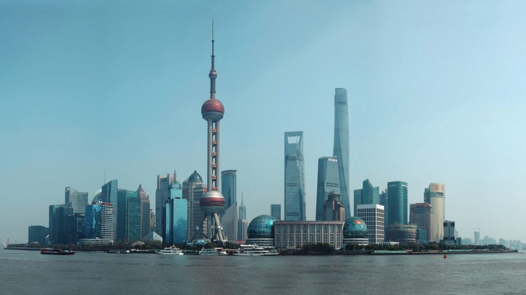 The coastline of Shanghai, China with the round Oriental Pearl Radio and TV Tower among the skyscrapers of the skyline.