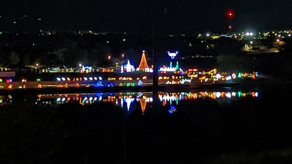 Walkway of Lights holiday display reflected in Lake LBJ, Marble Falls, Texas.