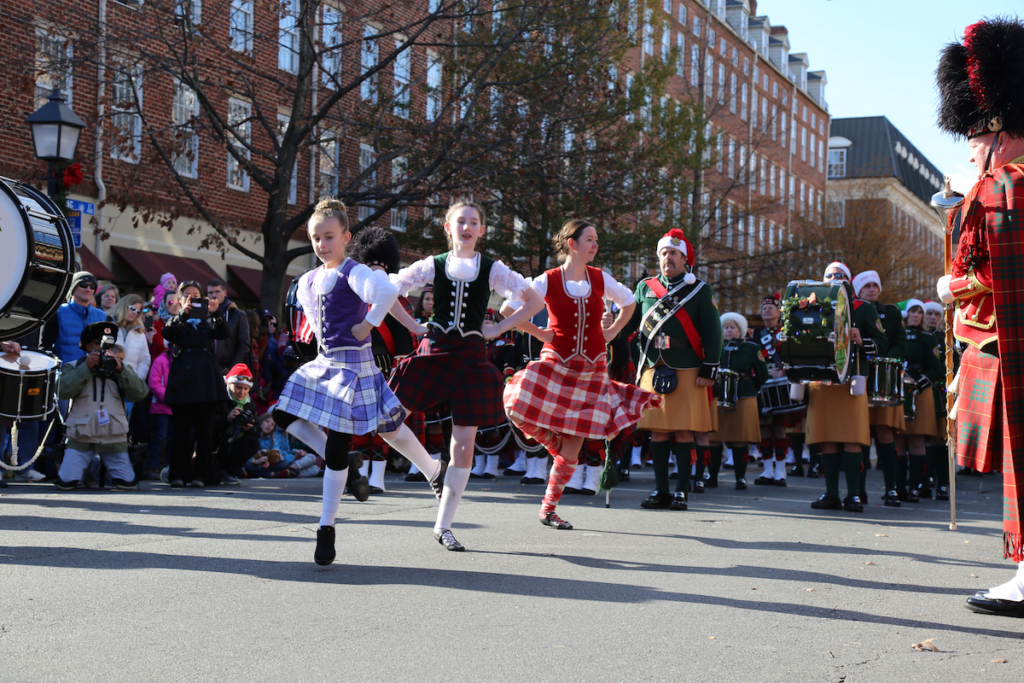 Young women dancing at the Scottish Christmas Walk Parade in Alexandria, Virginia. Photo by E Pallorina for Visit Alexandria.