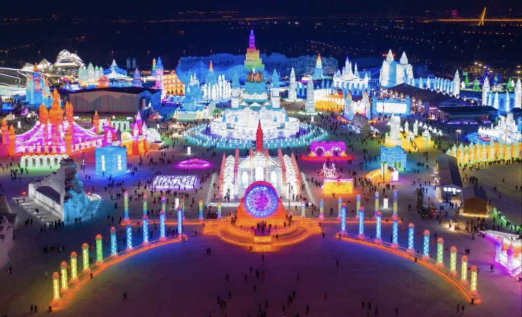 Aerial view of the Harbin International Ice Festival illuminated at night. Photo c. Modern Hotel, Harbin, China