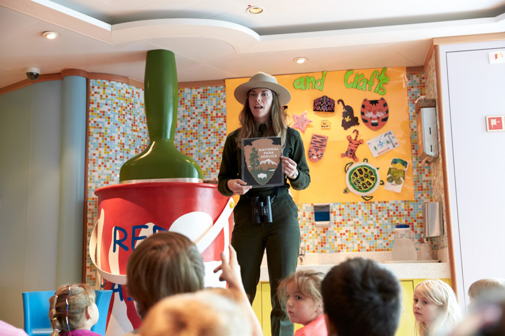 National Park Service ranger in Alaska leads kids on a Junior Ranger study program aboard a Holland America Line cruise ship.