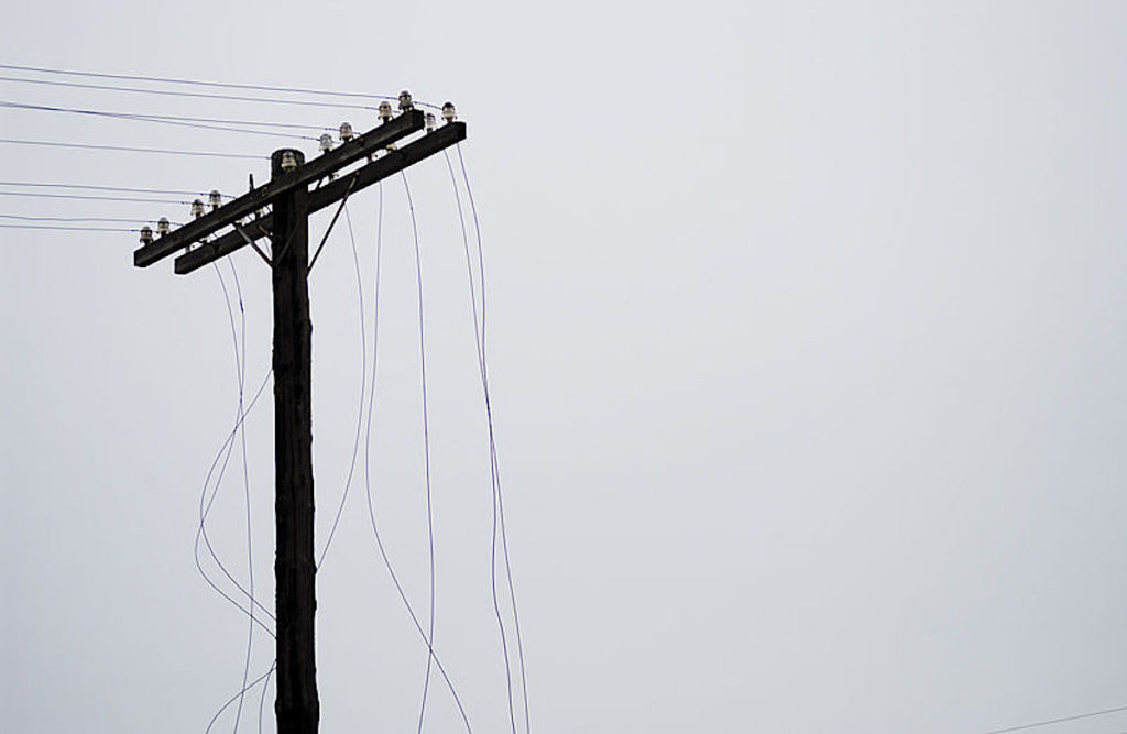 Borken power lines have electrical lines dangling.