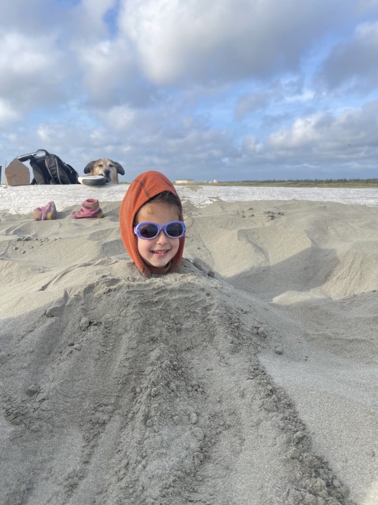 Burying my daughter on the beach Ocean City State Park, Washington. Photo by Lindsey Scot Ernst.