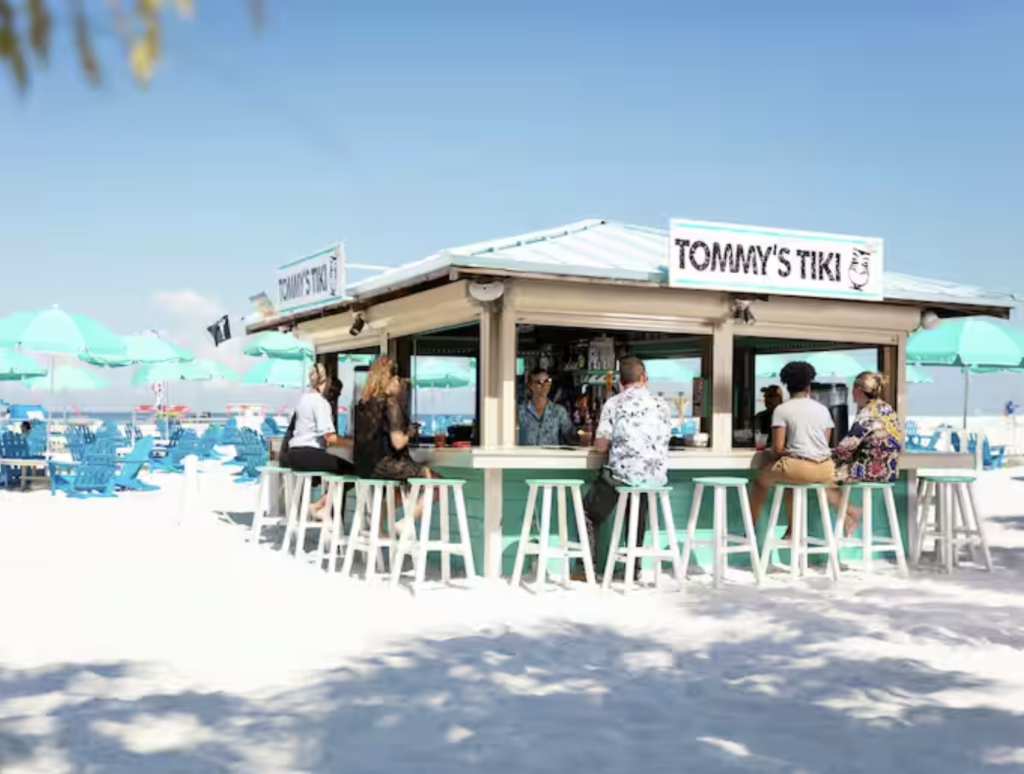 Vintage photo of guests enjoying the Tiki Bar on the sand outside the Hilton Clearwater Beach Resort. Photo c. Hilton