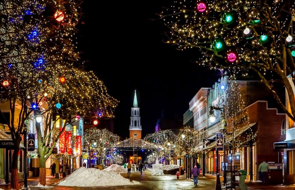 Small town with church decorated in holiday lights for the winter season. Phot by Michelle Raponi for pixabay