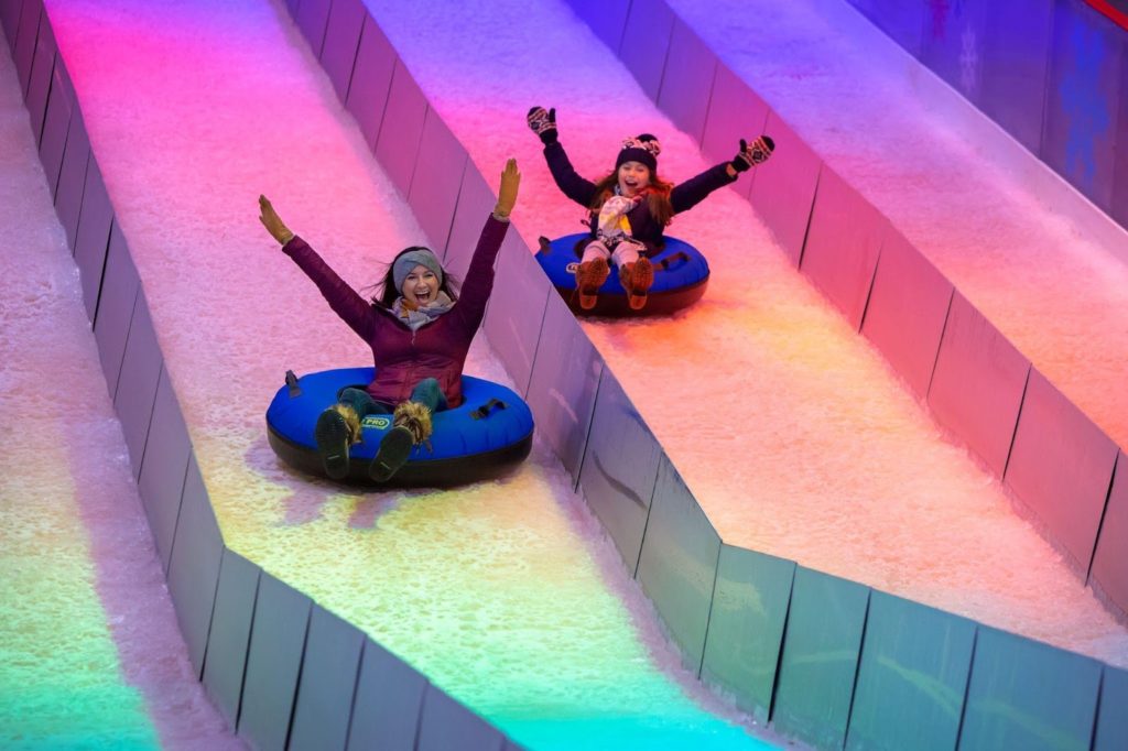 Kids sledding indoors at the JW Marriott Texas Hill Country resort during the winter holidays. Photo c. JW Marriott Hill Country