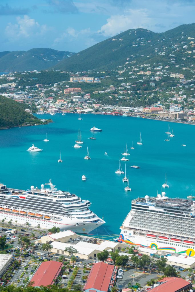 Aerial view of the Carnival Conquest and Norwegian Encore docked together at pier in Europe.