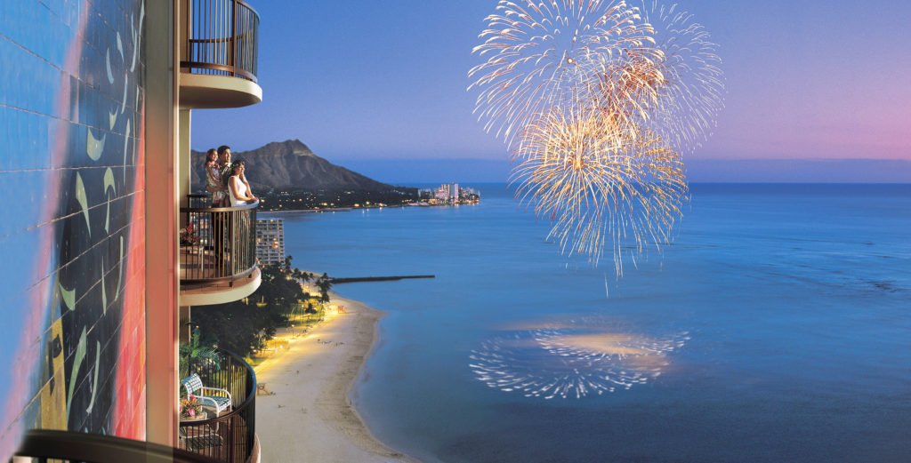 Hotel guests watch fireworks display over the Pacific Ocean from their balcony at Hilton Hawaiian Village Resort, Oahu. Photo c. Hilton