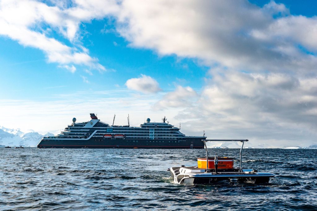 Seabourn's Sea Venture expedition ship off Antarctica, seen with submarine excursion vessel.