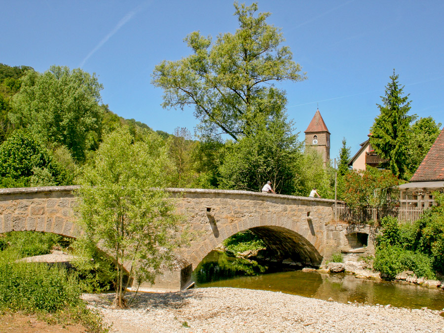 Bike over the River Tauber on a stone bridge as you discover the history of Rothenburg o.d.T. along Germany's Romantic Road. Photo c. Fuchsmuehle.de
