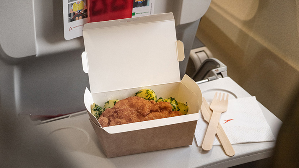 An Austrian Melangerie-to-go meal features local specialties served in a box with compostible utensils. c. Austrian Airlines