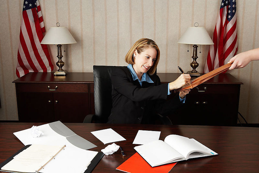 Woman notarizing a Child Travel Consent Letter for traveling internationally with a minor child.