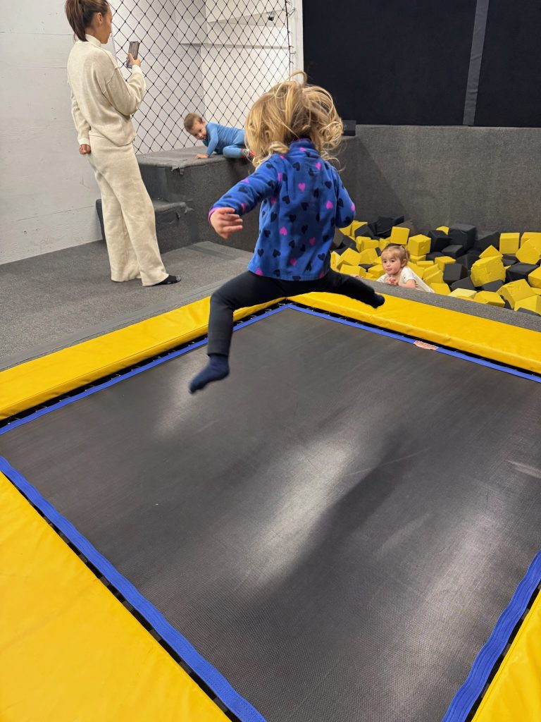 Young girl practices jumps on trampoline so she can ski with grandparents. Photo c. LauraSutherland