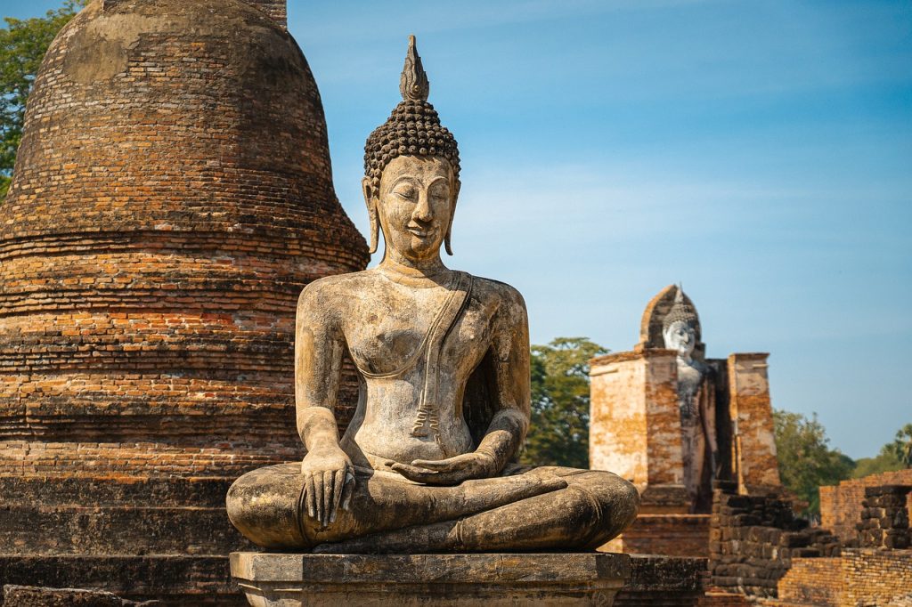 Classic seated Buddha in the Thai countryside. Photo c. Qimono for pixabay.