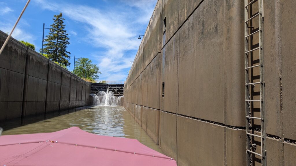 Red roof of Erie Canal barge enters Lock 32 heading eastbound on a New York canal vacation.