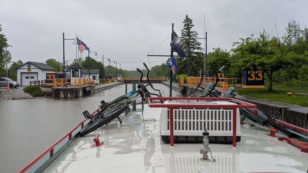 Canal barge with bikes on the roof deck approaches Lock 33 on New York's Erie Canal.