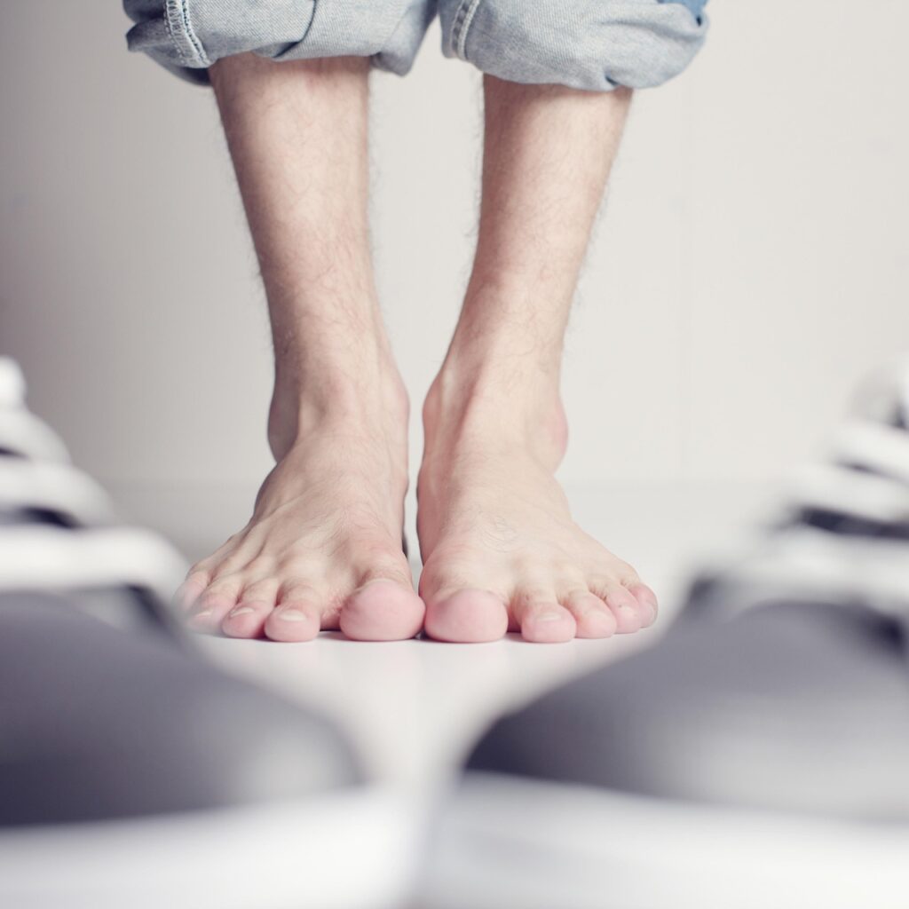 Barefoot man with shoes nearby. Photo c. Andreas160578 for pixabay.