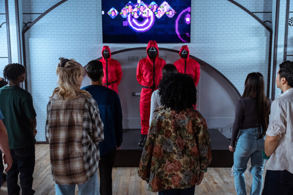 Players confront costumed guards in 'Squid Games The Experience', an immersive game in New York.