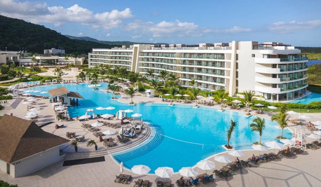 Large freeform pool follows the shape of this five-story all inclusive resort hotel.