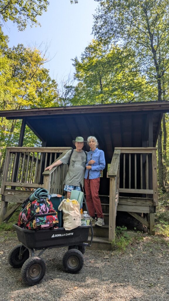 Couple arrives at Harriman State Park AMC Campground to set up in a shelter.