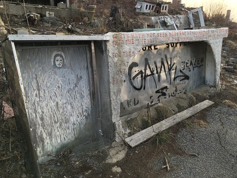 The Faded Biblical Murals on Concrete Walls