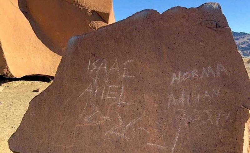 Scratching Names And Dates Into The Rock