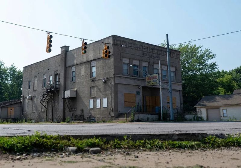 Deserted Storefronts Leaning Into the Wind