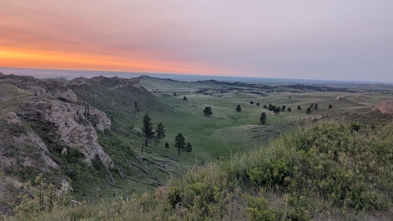 Forested Ridges Rising Above Wide Open Grasslands