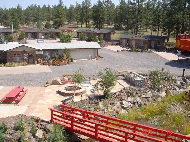 Historic Route 66 Setting With Forest Backdrop