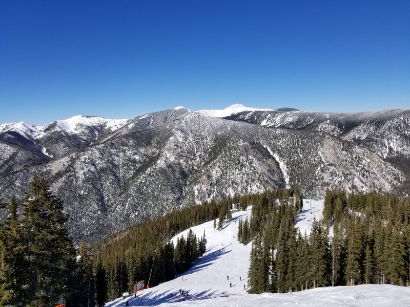 Starting in Taos With Adobe Streets Framed by Snowy Peaks