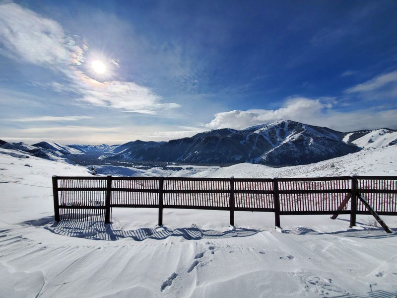 Snowcat tours across a white horizon