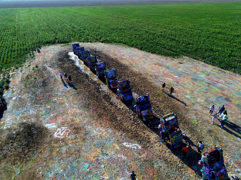 A Surreal Line of Cadillacs in the Middle of the Plains