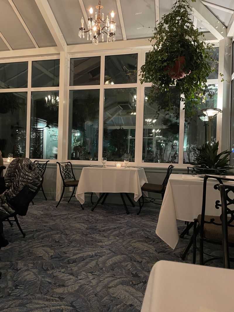 Intimate Greenhouse Dining Room With Natural Ambiance