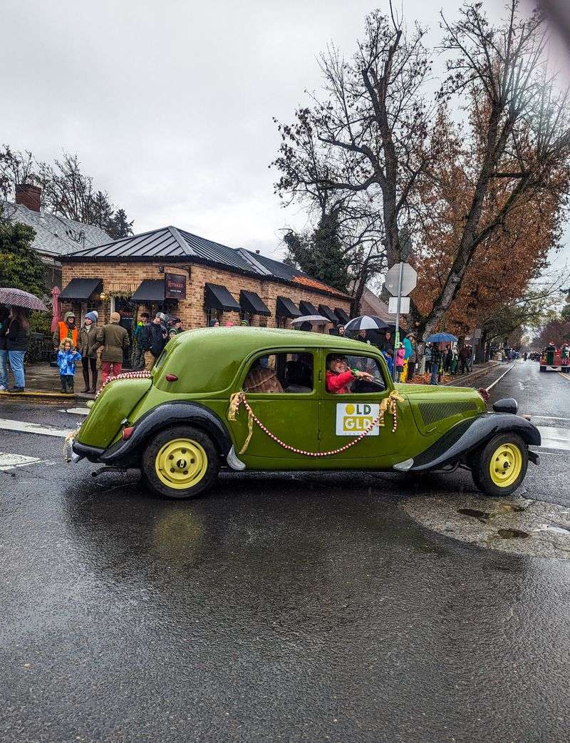 Carolers Drifting Between Brick Storefronts