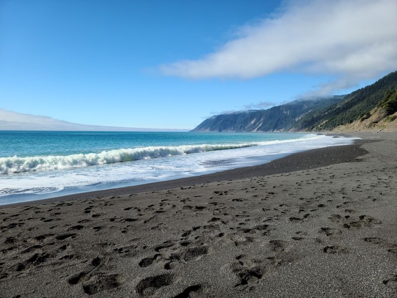 The Jet-Black Sand Immediately Changes Your Sense Of Place