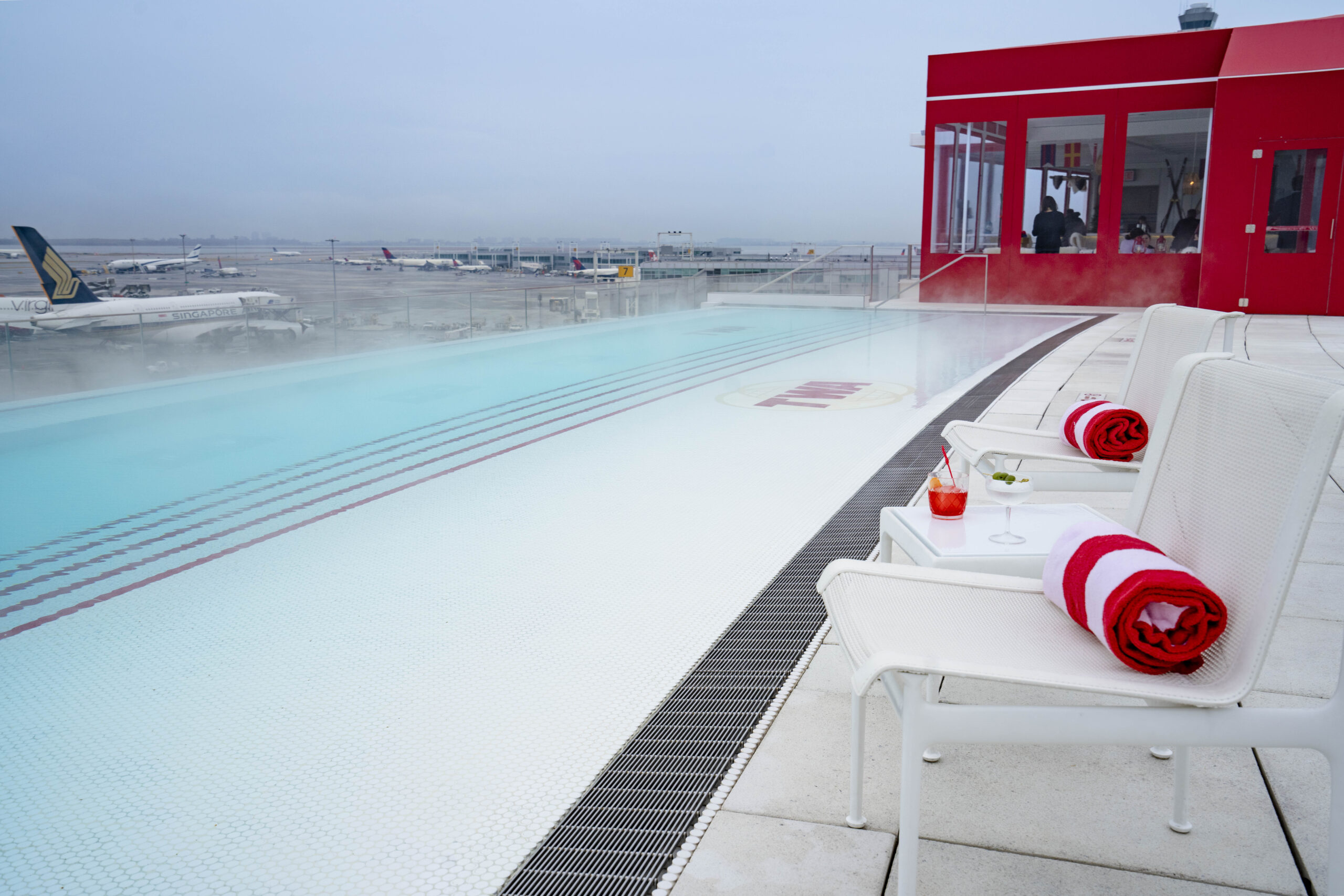 Rooftop pool at the TWA Hotel at JFK overlooks the Jetblue runway!