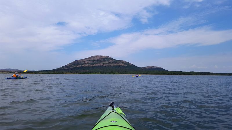 Boating on Open Water With Mountains All Around