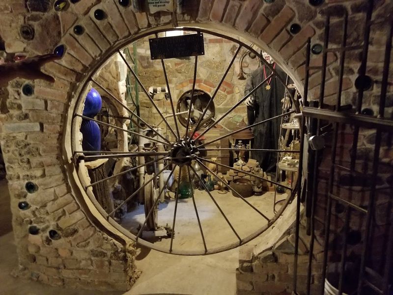 A Circular Door Covered in Shells