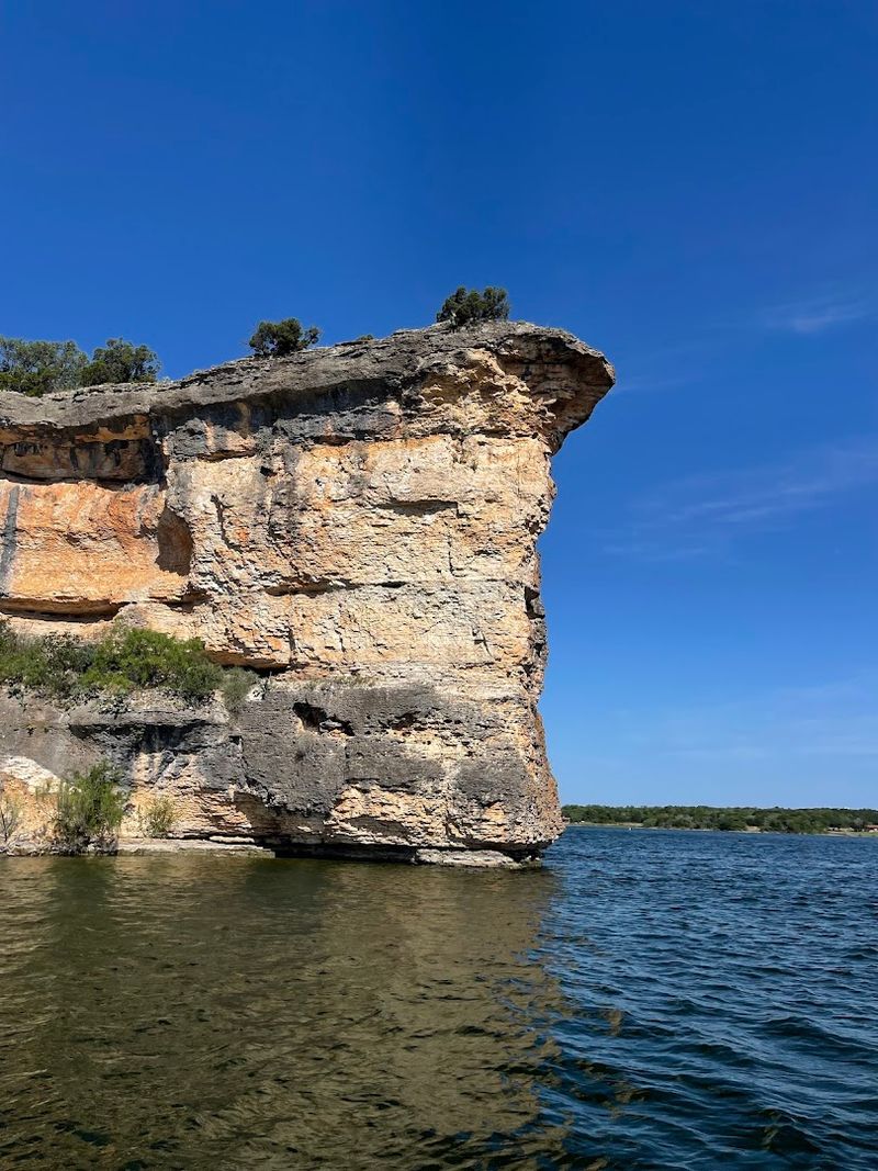 Dramatic Rock Walls And Limestone Cliffs That Frame The Lake