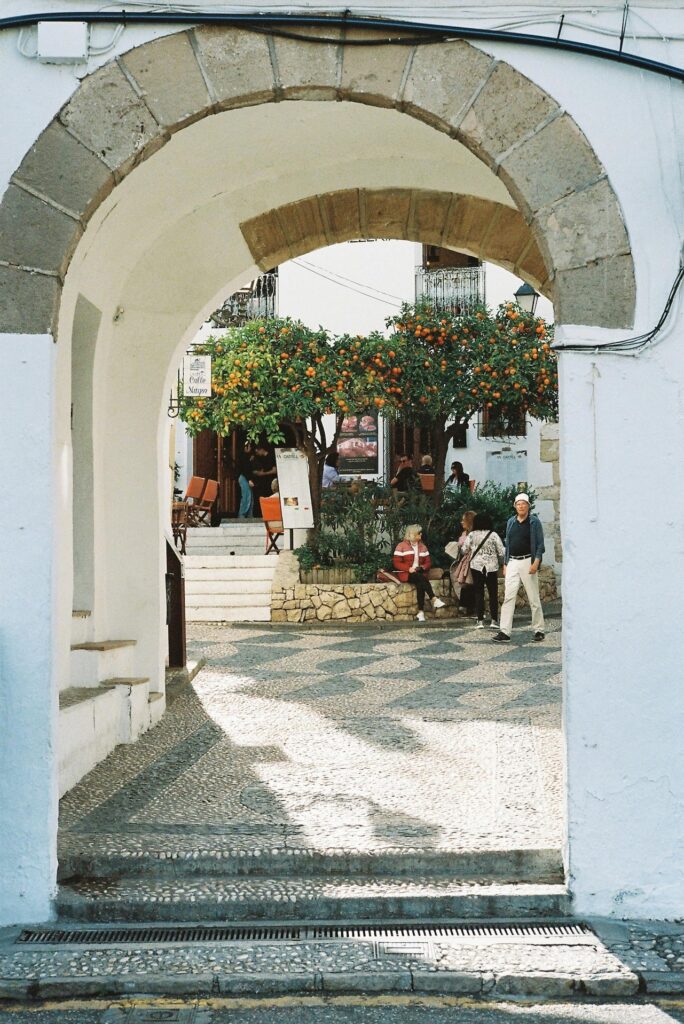 Relax in the island's tranquil town squares at classic cafes. c. Alec Doua for pexels.