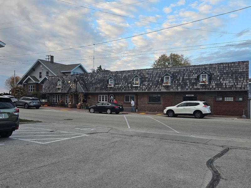 Brick Exterior With A Cedar Shake Roof