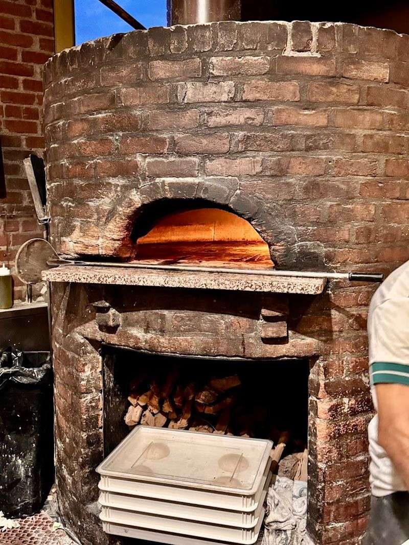 Wood Fired Oven Glowing Behind A Glass Window