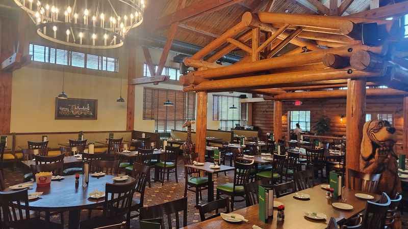 Exposed Wood Beams And A Stone Fireplace Inside