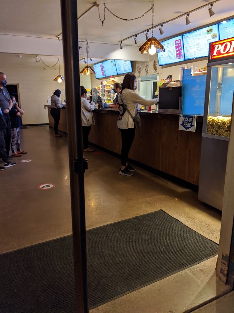 The Snack Bar Window Slinging Popcorn And Hot Dogs