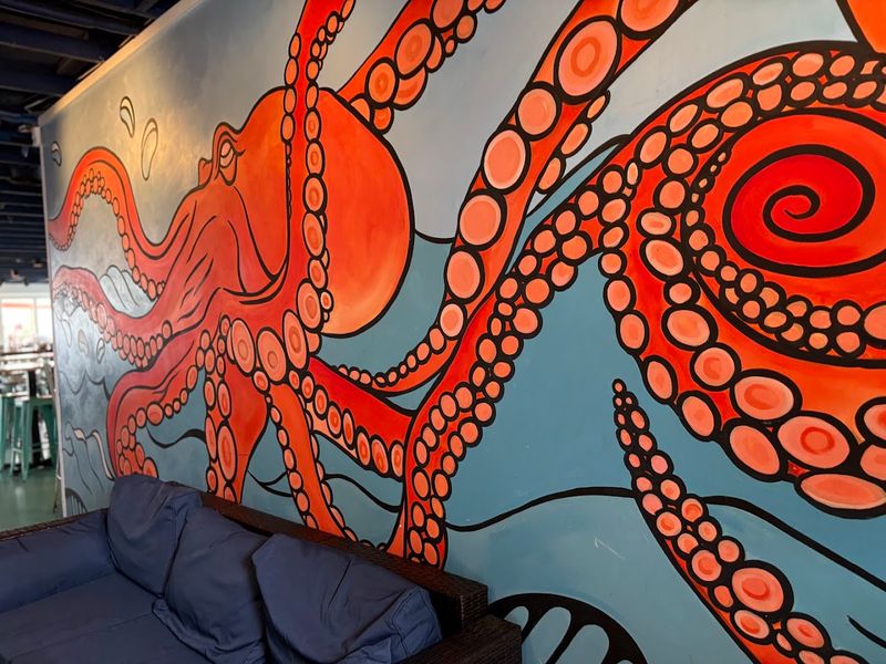 Vibrant Murals Of An Octopus And A Lighthouse