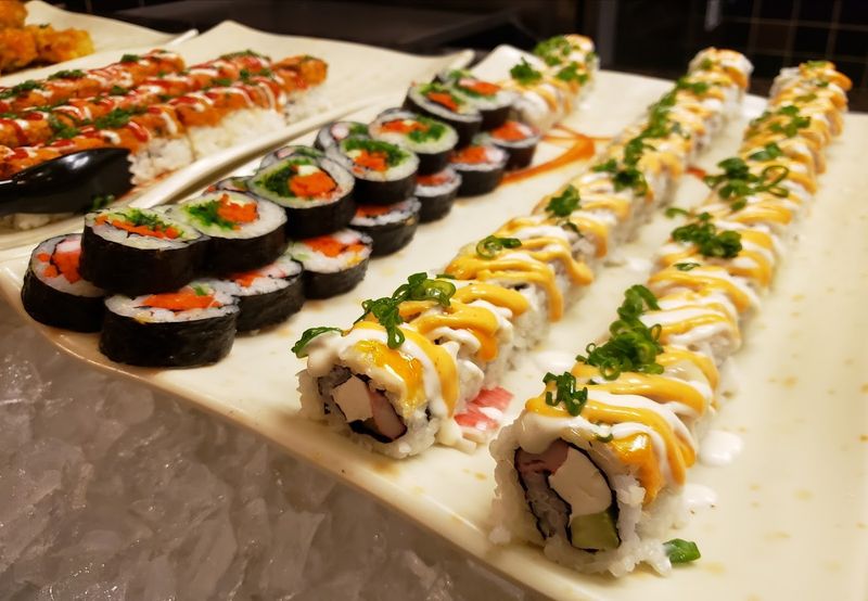 A Sushi Bar Spinning Fresh Rolls Throughout Service