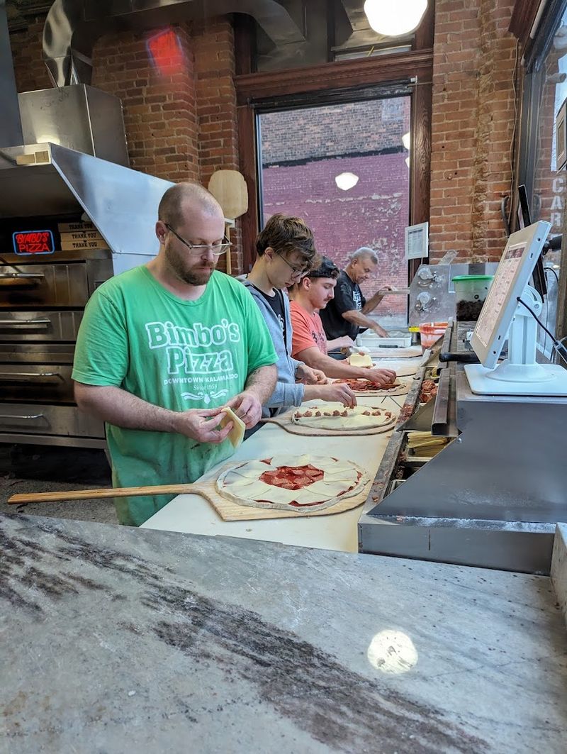 Kids Watch The Pizza Makers From The Counter