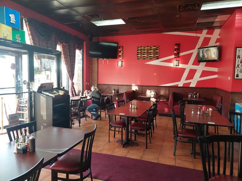 Long Picnic Tables Under A Tall Metal Awning